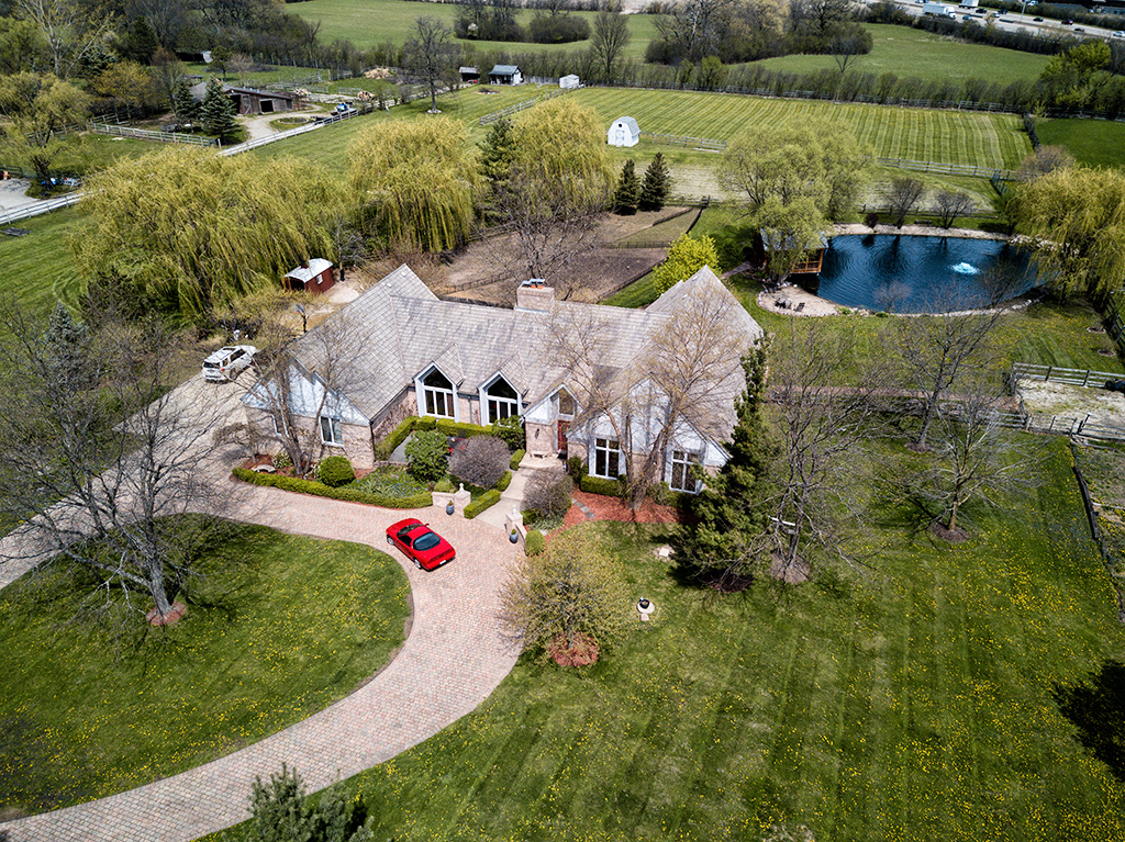 aerial drone view of house land and water