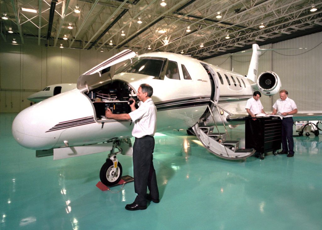 airplane hangar maintenance with mechanics